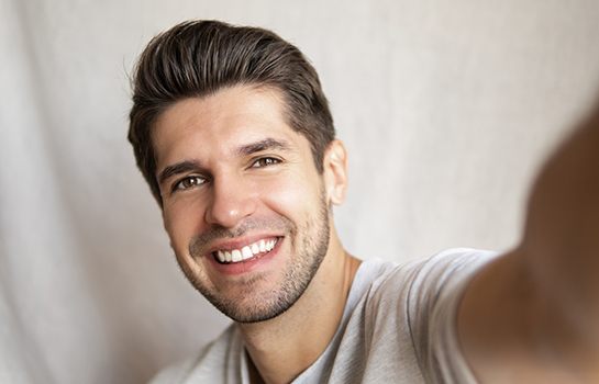 Selfie portrait of smiling, handsome man