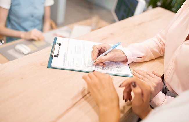 Dental patient completing dental insurance forms