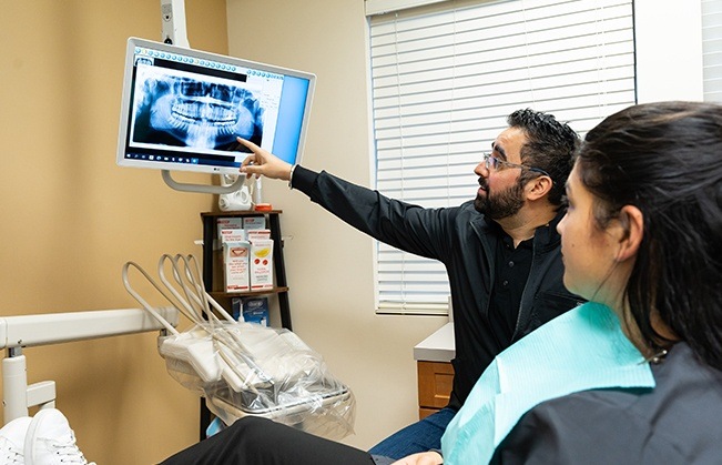 Dentist and patient looking at dental x-rays