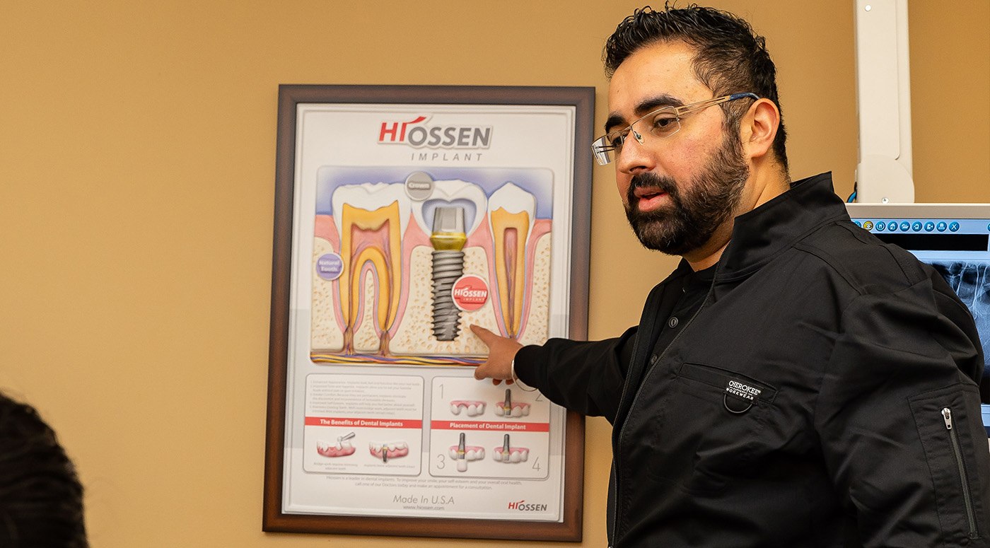 Dentist showing patient a dental treatment plan sample