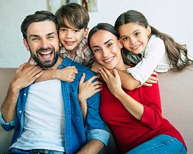 Family of four laughing together