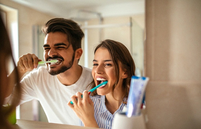 Couple brushing their teeth together