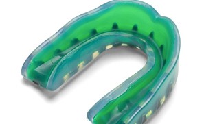 A green mouthguard designed to prevent oral injuries