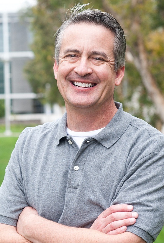 Man with healthy smile after replacing missing teeth