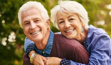Man and woman with healthy smiles after preventive dentistry