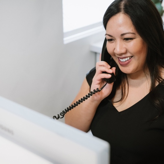 Woman calling dental office to discuss dental insurance