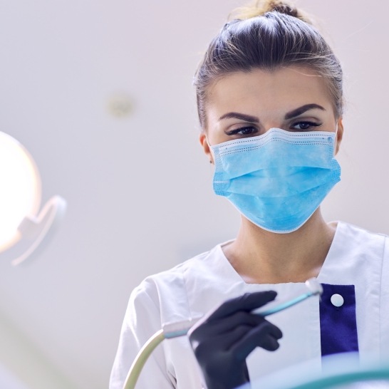 Dental team member wearing protective face mask to keep patients safe