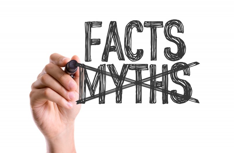 hand crossing out myths