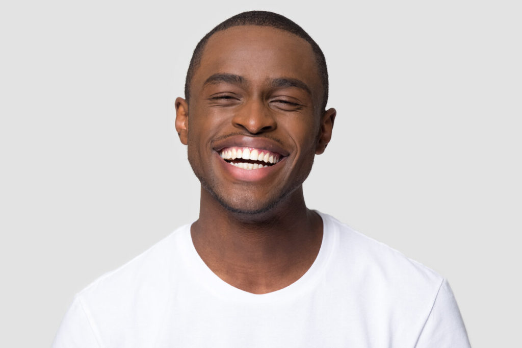 person will nice smile enjoying cosmetic benefits of dental implants in Auburn