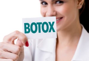 Woman holding BOTOX card