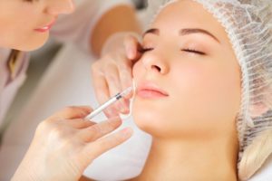 woman getting BOTOX injection from her cosmetic dentist