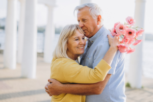 an older couple smiling and hugging